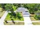 Aerial view of a home with an attached three-car garage and screened-in lanai at 12435 Oak St, San Antonio, FL 33576