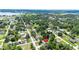 Aerial view of the property in a residential neighborhood with nearby lake at 12435 Oak St, San Antonio, FL 33576