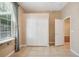 Bedroom featuring tile floors, large closet, a window with curtain, and neutral paint at 12435 Oak St, San Antonio, FL 33576
