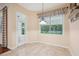 Charming breakfast nook with tile floor, natural light from large window, and outdoor access at 12435 Oak St, San Antonio, FL 33576