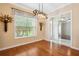 Formal dining room with hardwood floors, decorative window valance and modern chandelier at 12435 Oak St, San Antonio, FL 33576
