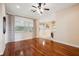 Bright dining room boasts hardwood floors and a large window with neutral-toned draperies for natural light at 12435 Oak St, San Antonio, FL 33576