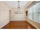 Dining room with hardwood floors, window with blinds, modern light fixture, and neutral paint at 12435 Oak St, San Antonio, FL 33576