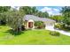 Charming home with well-manicured lawn, complemented by mature trees and landscaping, offering a welcoming and serene environment at 12435 Oak St, San Antonio, FL 33576