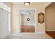 Inviting foyer with a glimpse into a living room featuring hardwood floors and an ornate mirror at 12435 Oak St, San Antonio, FL 33576