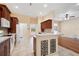 Kitchen with dark wood cabinetry, white appliances, and tile flooring at 12435 Oak St, San Antonio, FL 33576