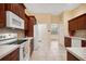 Bright eat-in kitchen with tile floor, white appliances, and access to the breakfast nook at 12435 Oak St, San Antonio, FL 33576