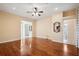 Spacious living room featuring hardwood floors, neutral paint, ceiling fan, and natural light at 12435 Oak St, San Antonio, FL 33576