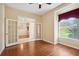 Office space featuring hardwood floors and a bay window with burgundy curtains, creating a cozy work environment at 12435 Oak St, San Antonio, FL 33576