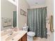 Neutral guest bathroom features a granite vanity and shower/tub combo at 12443 Adventure Dr, Riverview, FL 33579