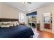 Comfortable bedroom featuring a plush bed, ceiling fan, and access to the bathroom and backyard pool area at 12443 Adventure Dr, Riverview, FL 33579