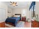 Comfortable bedroom featuring a plush bed, ceiling fan, and view of the backyard pool area at 12443 Adventure Dr, Riverview, FL 33579