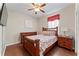 Cozy secondary bedroom featuring wood floors, ceiling fan and a large window at 12443 Adventure Dr, Riverview, FL 33579