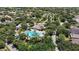 Overhead view of a well-maintained community pool and recreation center surrounded by tropical greenery at 12443 Adventure Dr, Riverview, FL 33579