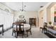 Formal dining room with a table set for four, showcasing elegant window treatments and a view of the hallway at 12443 Adventure Dr, Riverview, FL 33579