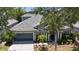 Charming single-Gathering home featuring a well-manicured lawn and a two-car garage with beautiful landscaping at 12443 Adventure Dr, Riverview, FL 33579