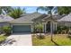 Charming single-Gathering home featuring a well-manicured lawn and a two-car garage with beautiful landscaping at 12443 Adventure Dr, Riverview, FL 33579