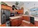 Spacious kitchen features stainless steel appliances, an island, and wood cabinets at 12443 Adventure Dr, Riverview, FL 33579