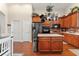 Modern kitchen with stainless steel appliances, wood cabinets, and central kitchen island at 12443 Adventure Dr, Riverview, FL 33579