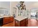 Kitchen island with marble countertop, wooden cabinets, and hanging pot rack at 12443 Adventure Dr, Riverview, FL 33579