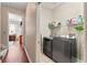 Laundry room with a washer and dryer, shelving, and nearby access to other parts of the home at 12443 Adventure Dr, Riverview, FL 33579