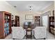 Comfortable living area with multiple bookshelves, a cozy sofa, and seamless access to the dining room at 12443 Adventure Dr, Riverview, FL 33579