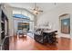 Inviting living room with high ceilings, hardwood floors, and access to outdoor patio with pool at 12443 Adventure Dr, Riverview, FL 33579