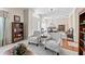 Cozy living room with plush armchairs, built-in shelving, and a view into the dining room at 12443 Adventure Dr, Riverview, FL 33579