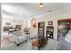 Open-concept living area with bookshelves, plush seating, and seamless flow to the dining area at 12443 Adventure Dr, Riverview, FL 33579