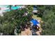Community playground with modern equipment and a colorful design, surrounded by lush landscaping at 12443 Adventure Dr, Riverview, FL 33579