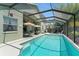 Relaxing outdoor pool and patio area surrounded by lush landscaping and comfortable seating at 12443 Adventure Dr, Riverview, FL 33579