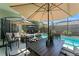 Outdoor patio and screened in pool area with an umbrella covered dining space at 12443 Adventure Dr, Riverview, FL 33579