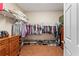 Well-organized walk-in closet featuring hardwood floors and shelving at 12443 Adventure Dr, Riverview, FL 33579