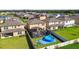 Aerial view showcasing a community, backyard pools, patios, and green lawns at 12643 Horseshoe Bend Dr, Lithia, FL 33547