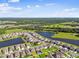 Aerial view showcasing the community's scenic location near a lake and surrounding wooded areas at 12643 Horseshoe Bend Dr, Lithia, FL 33547
