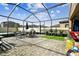 Large, screened-in backyard featuring outdoor seating, a grill, and ample space for entertaining at 12643 Horseshoe Bend Dr, Lithia, FL 33547