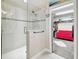 Modern bathroom boasts a glass shower and a walk-in closet with a stylish red sofa at 12643 Horseshoe Bend Dr, Lithia, FL 33547