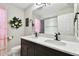 Bathroom features a double sink, a floral wreath, and a shower at 12643 Horseshoe Bend Dr, Lithia, FL 33547