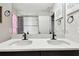 Spacious bathroom featuring double sinks, a large mirror, and framed art at 12643 Horseshoe Bend Dr, Lithia, FL 33547