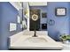 Close-up of a bathroom featuring blue walls, white marble countertop, and modern black fixtures at 12643 Horseshoe Bend Dr, Lithia, FL 33547