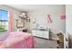 Well-lit bedroom featuring a desk area and a window with natural light at 12643 Horseshoe Bend Dr, Lithia, FL 33547