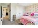 Bright bedroom with pink decor, closet, and a large window at 12643 Horseshoe Bend Dr, Lithia, FL 33547