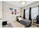 Cozy bedroom with a black and white checkered comforter, fluffy rug, and a desk with a gaming chair at 12643 Horseshoe Bend Dr, Lithia, FL 33547