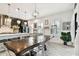 Dining room with view of the kitchen featuring a large dining table and stylish lighting at 12643 Horseshoe Bend Dr, Lithia, FL 33547