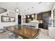 Modern dining area open to the kitchen, featuring elegant light fixtures at 12643 Horseshoe Bend Dr, Lithia, FL 33547