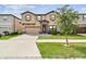 Charming two-story home showcasing a well-manicured lawn and neutral-toned exterior with a two car garage at 12643 Horseshoe Bend Dr, Lithia, FL 33547