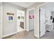 Hallway with an array of doors leading to various rooms and cute wall decor at 12643 Horseshoe Bend Dr, Lithia, FL 33547