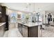 Bright, open kitchen with quartz countertops, white tile flooring, and views of the outdoor living space at 12643 Horseshoe Bend Dr, Lithia, FL 33547