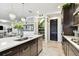 Kitchen with a large island, stainless steel appliances, quartz countertops, and walk in pantry at 12643 Horseshoe Bend Dr, Lithia, FL 33547