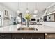 Kitchen island with sink and seating overlooks the living room with view of the outside patio at 12643 Horseshoe Bend Dr, Lithia, FL 33547